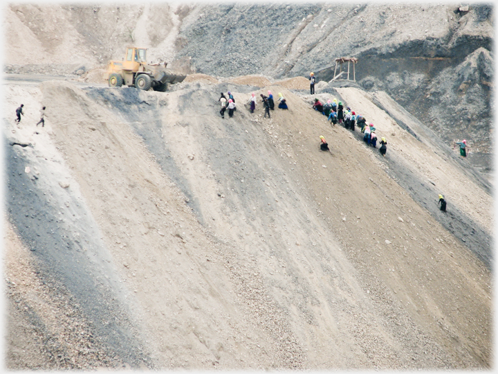 Steep slope of spoil heap with people on it.