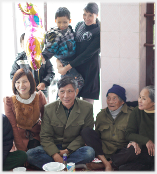 Family group sitting and standing at lunch