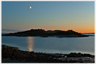 Moon rising over island.