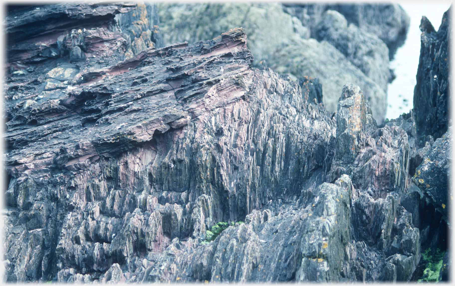 Horizontal layered rocks over vertical layered rocks.