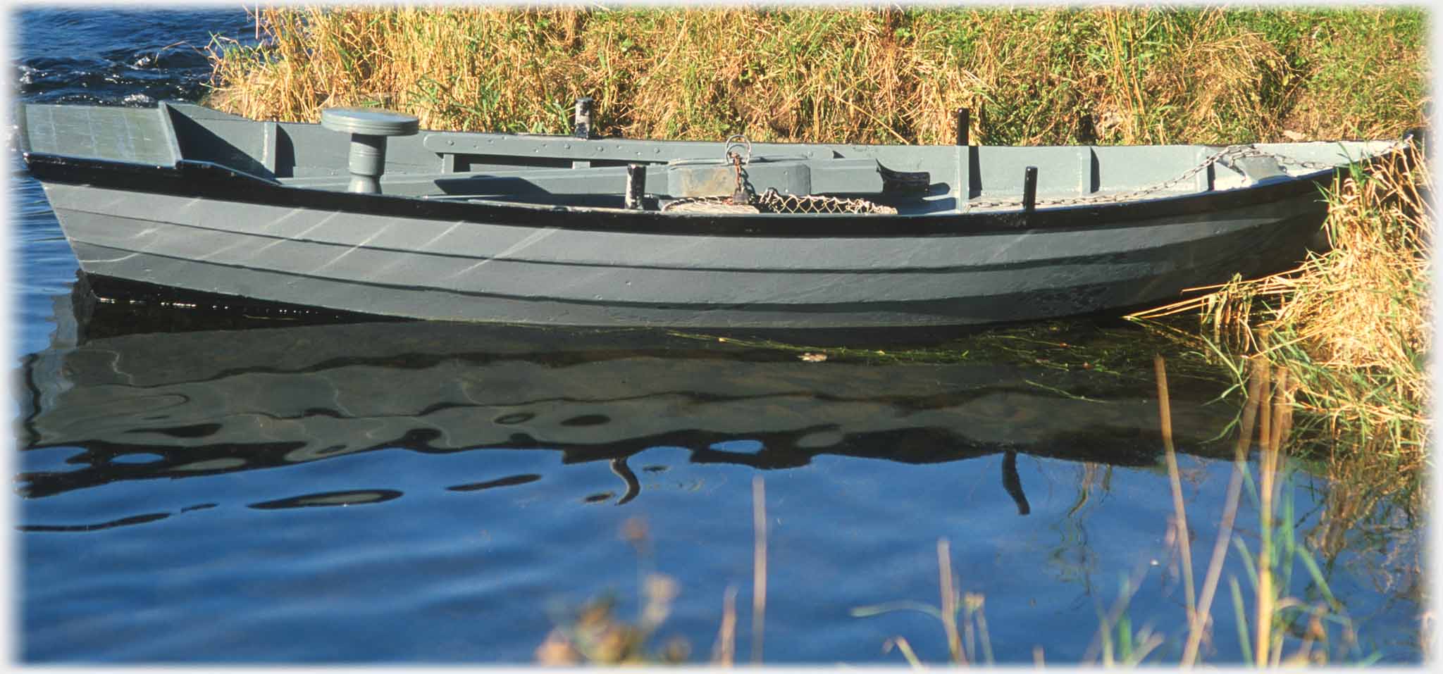 Boat, from previous photo, with marbled water beside it.