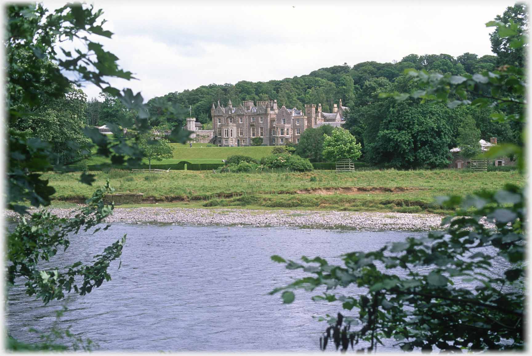 River with mansion beyond.