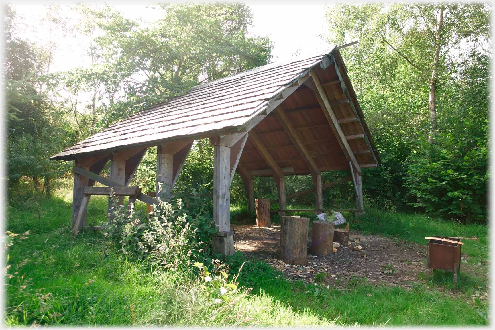 High roof over workshop area with no walls.