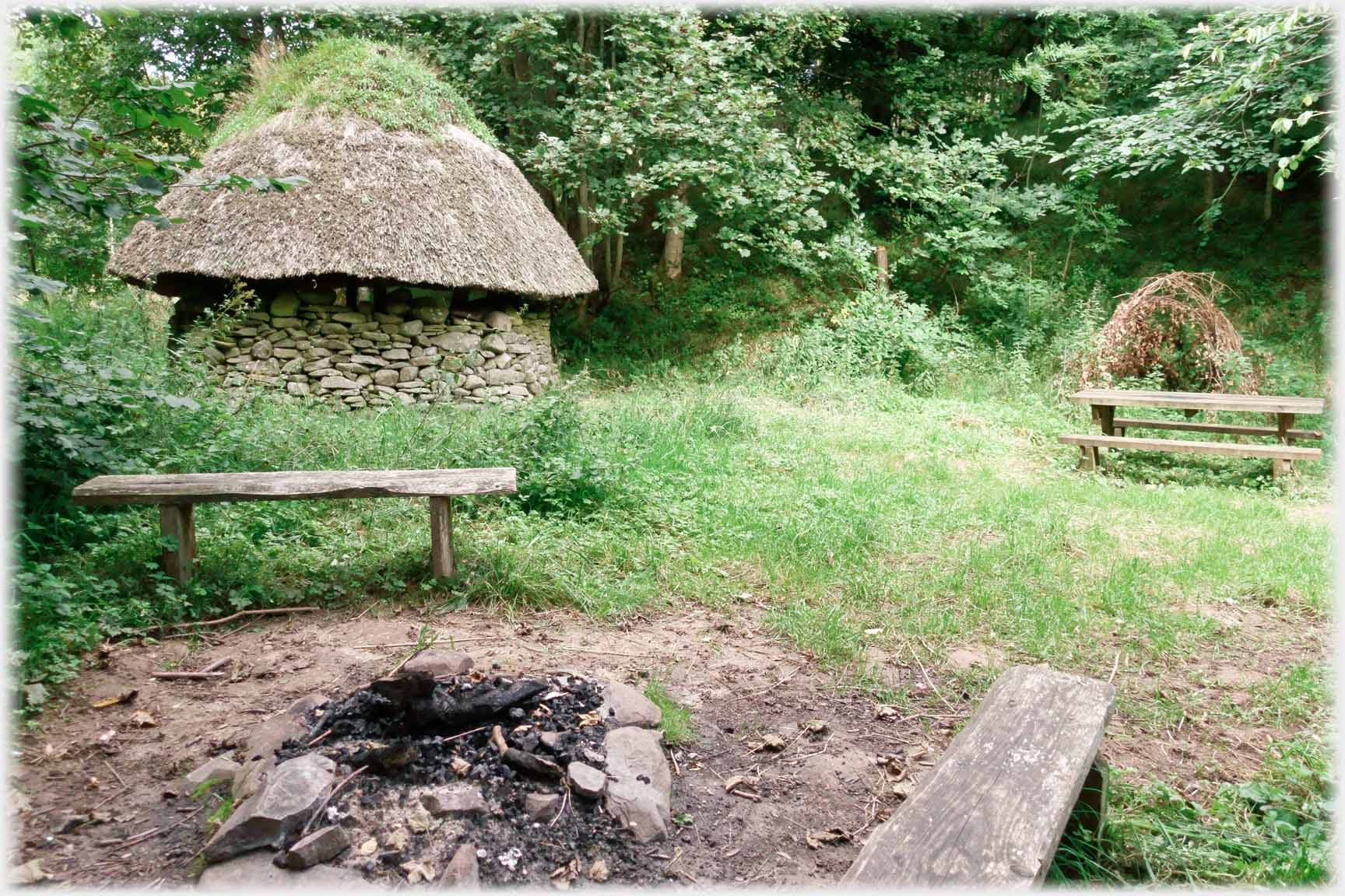 Benches near round thatched hut.