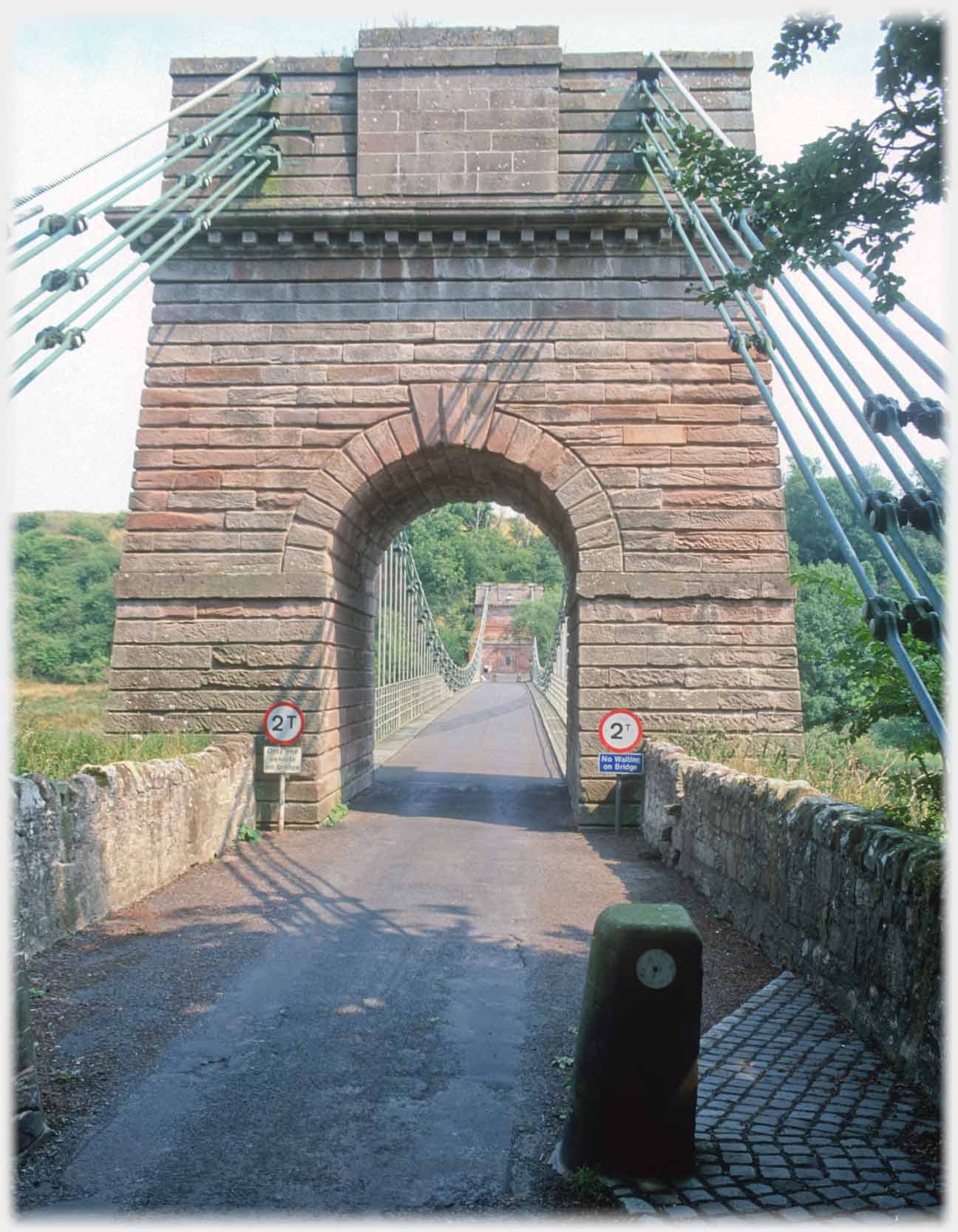 Approaching the arch of one of the suspension bridge's pillars.