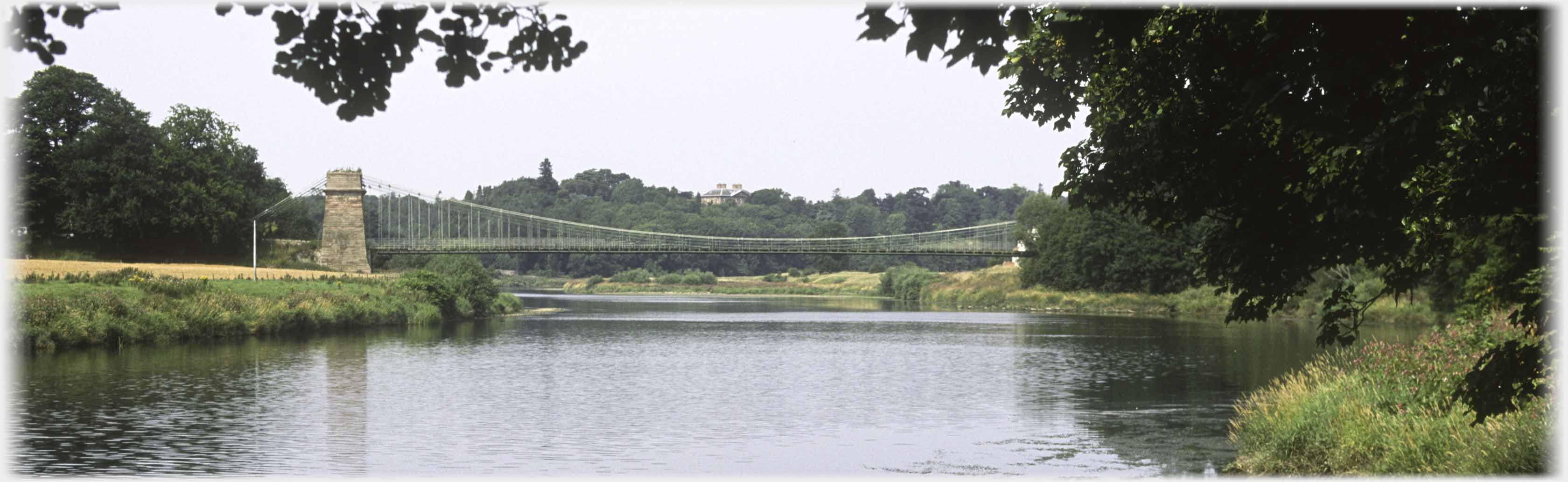 The suspension bridge seen from a few hundred yards upstream