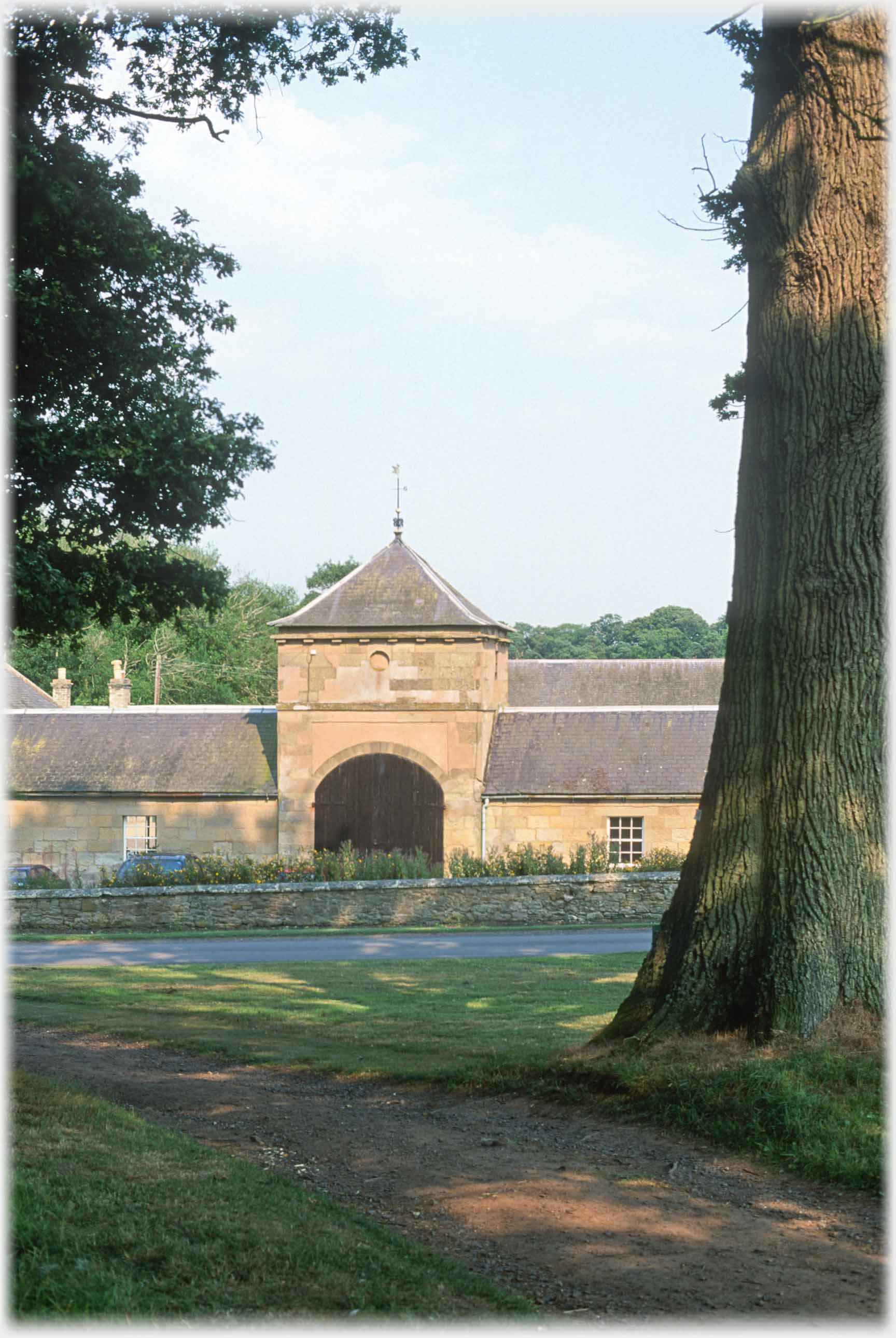 Low tower with very large doors in line of buildings.