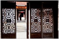 Door into courtyard with Chinese characters above.