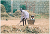 Man sweeping, with child beside him.