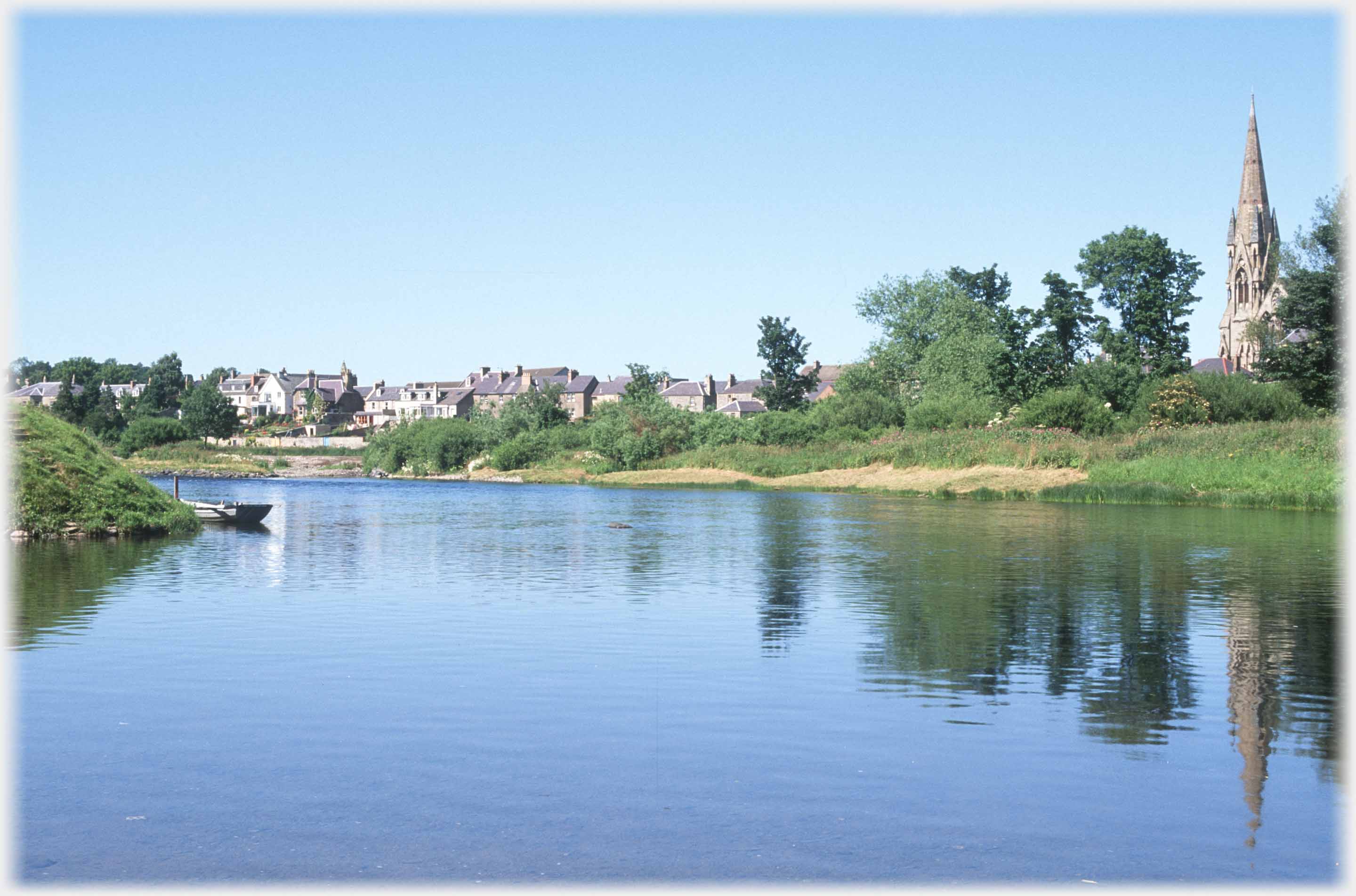 River with church spire reflected at right.