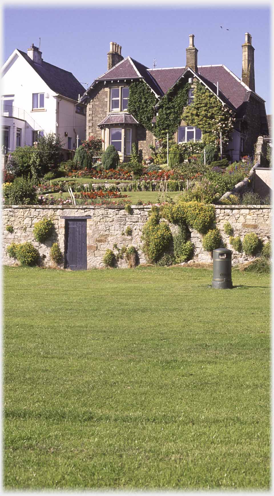 House with grass in front.