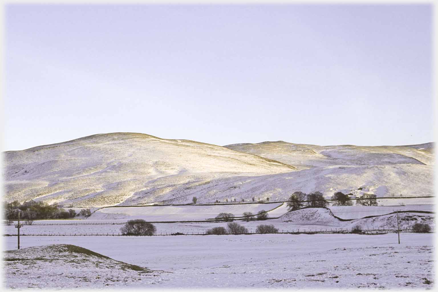 Golden light catching valley hills.