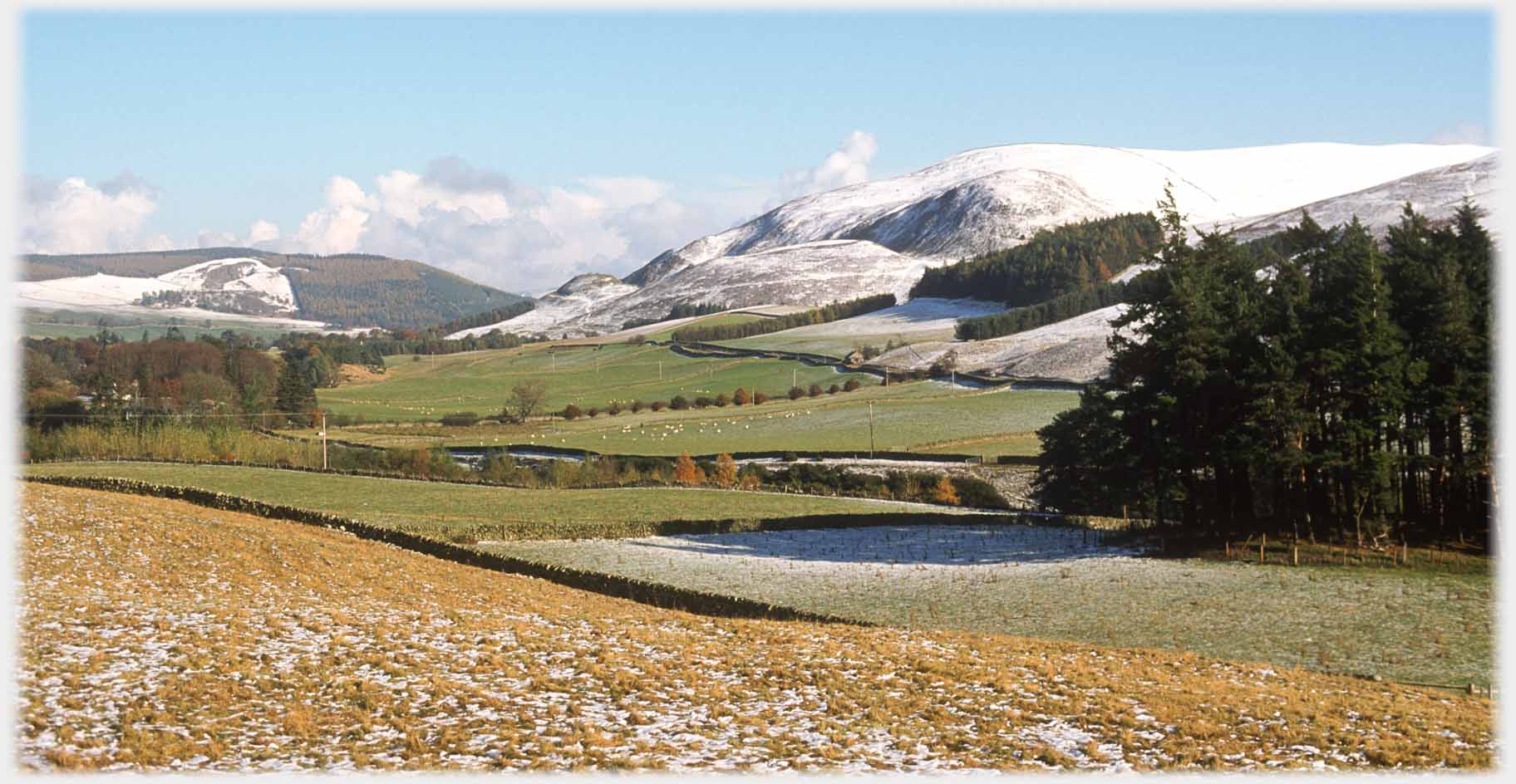 Complex hill surfaces with snow running down to valley.