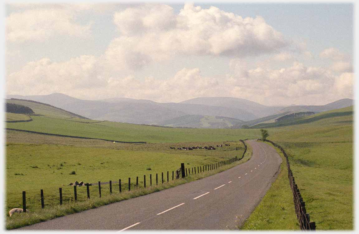 Road pointing at large distant hill.