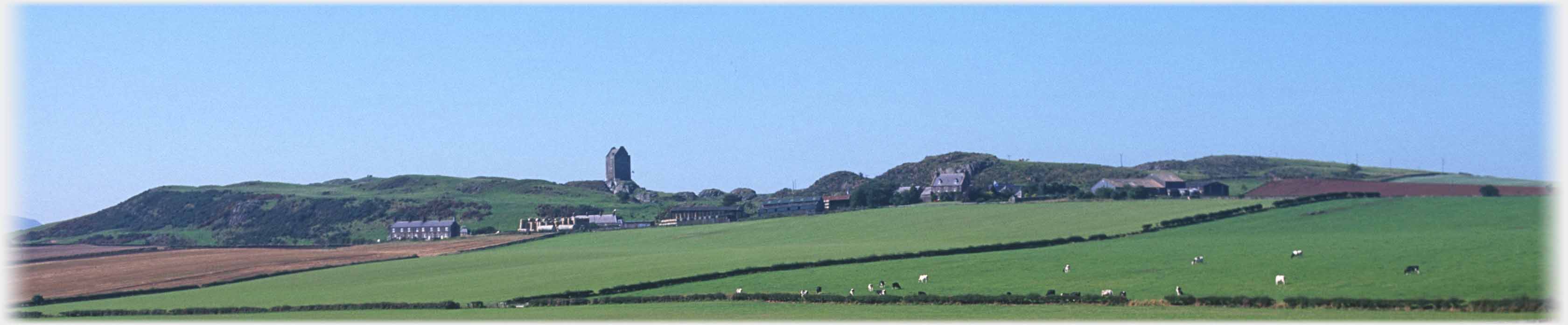 Rocky panorama of horizon with tower house and other houses very small.