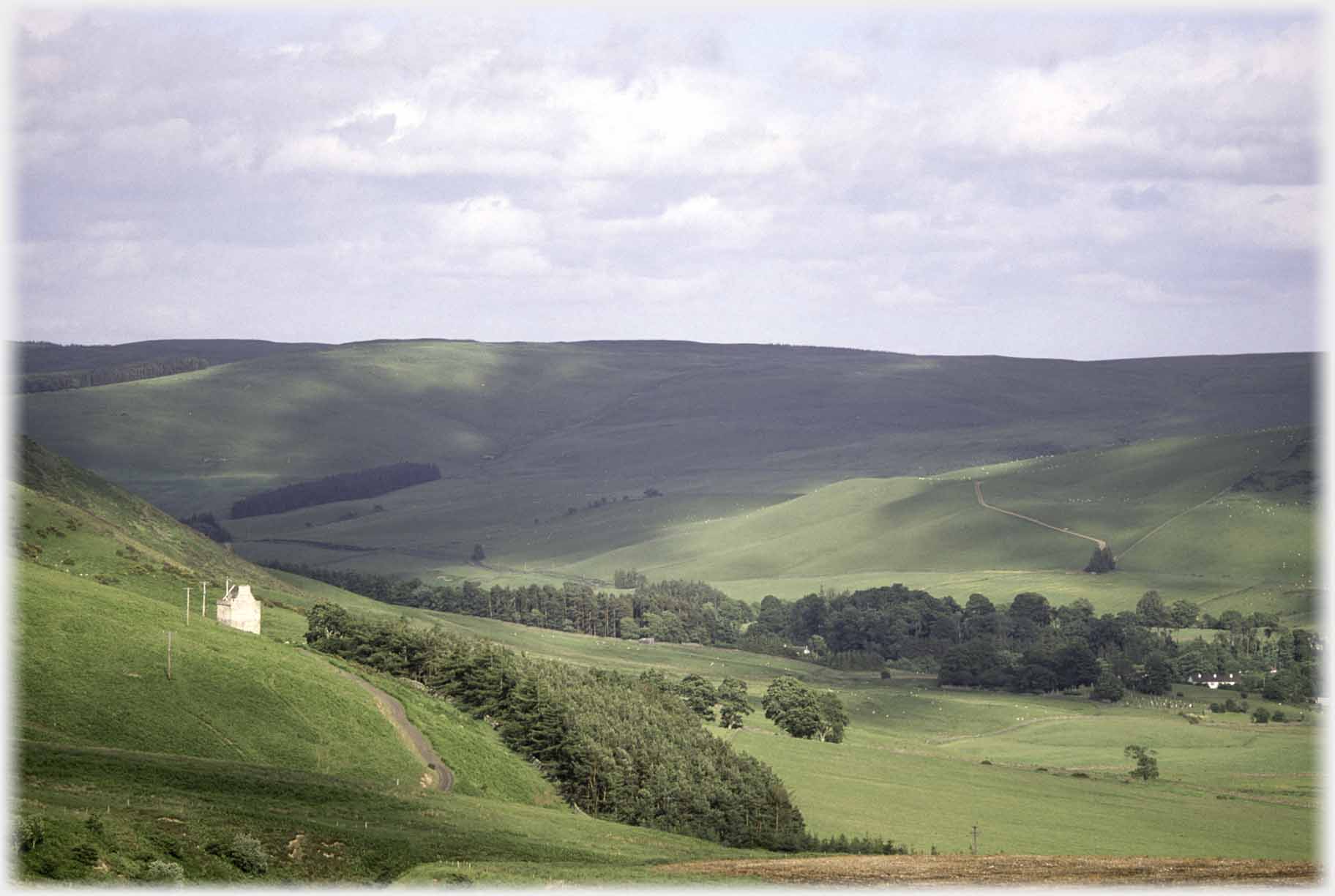 Tower house overlooking wide green open valley.