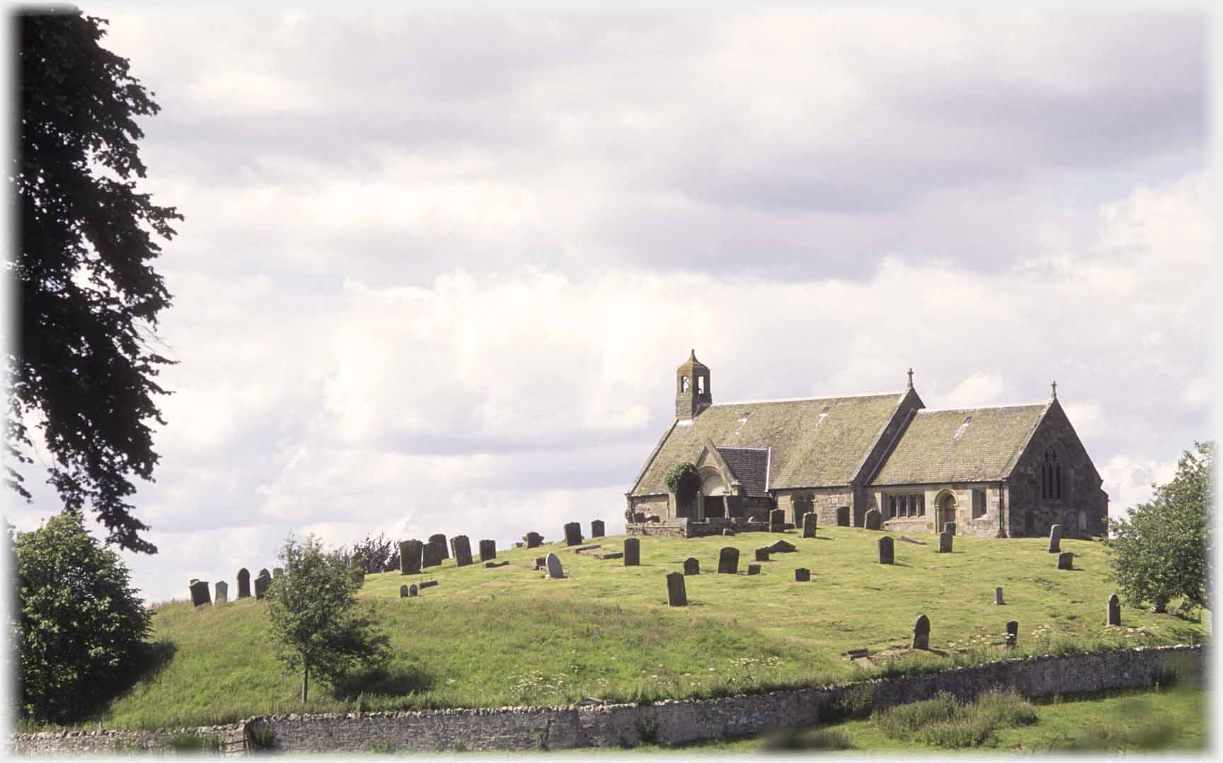 Chapel on hillcrest gravestones around.