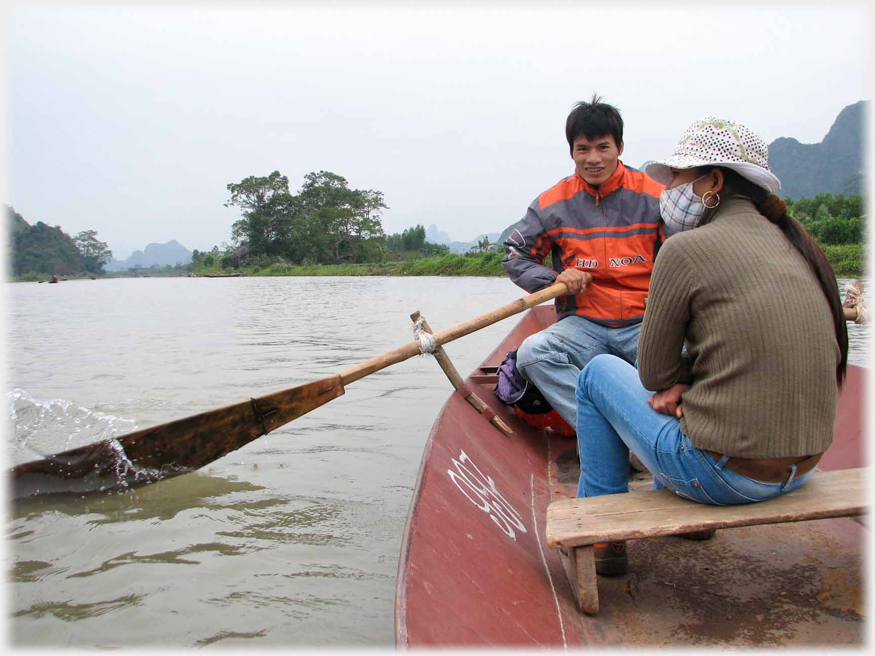 Rower with woman sitting opposite.