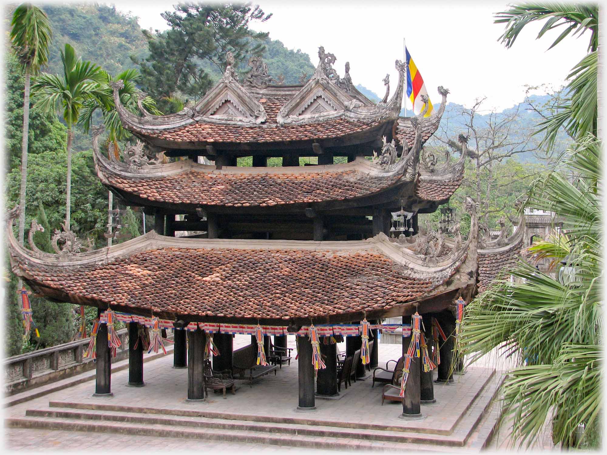 Three tiered roofed building on pillars with open ground floor.