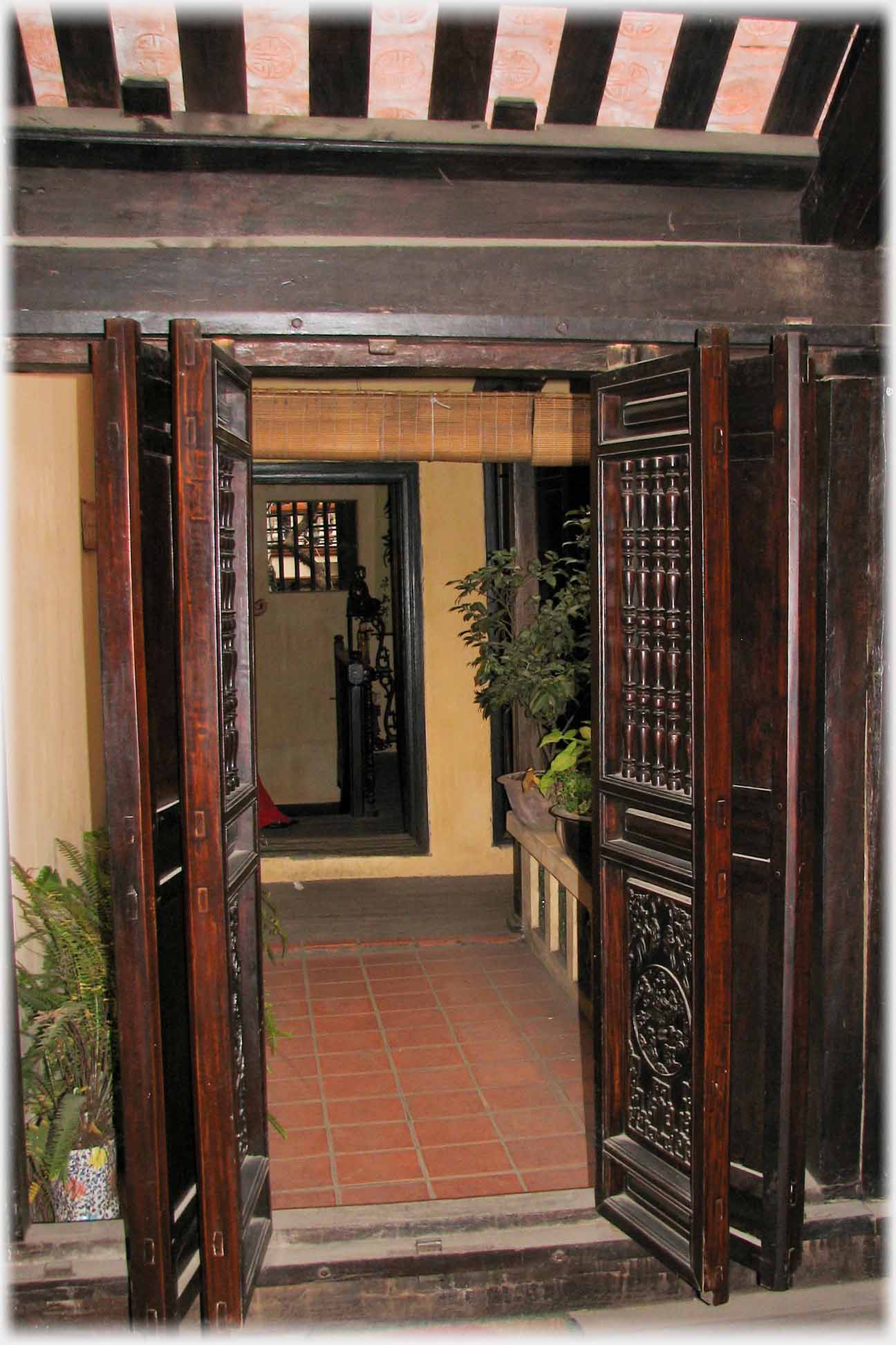 Set of carved wooden doors standing open.