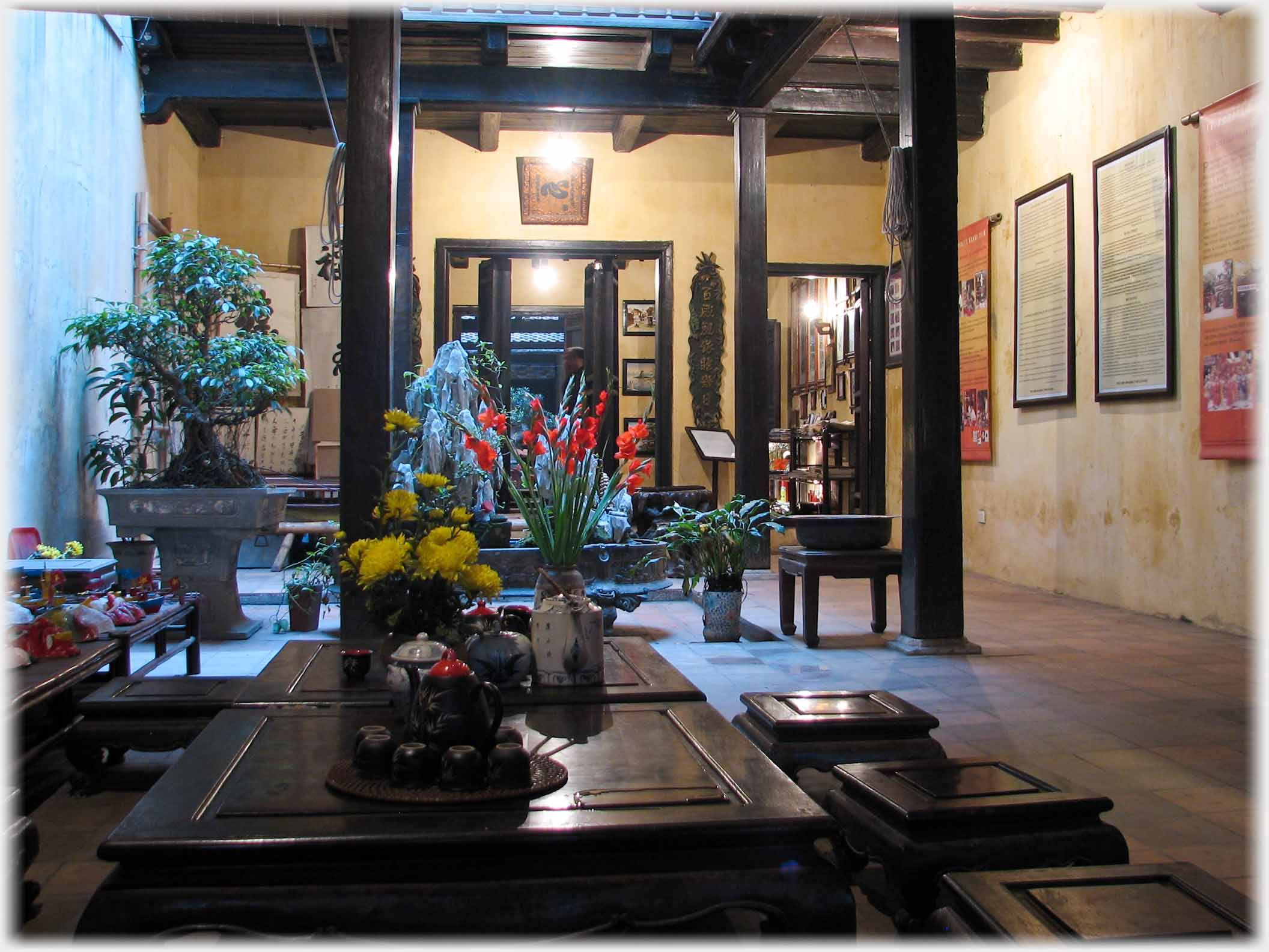 Interior photo of large traditionally furnished room with pillars supporting ceiling.