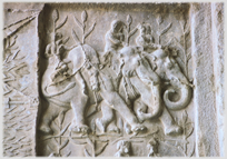 Bas-relief of three spightly elephants with people and a hog on their backs.