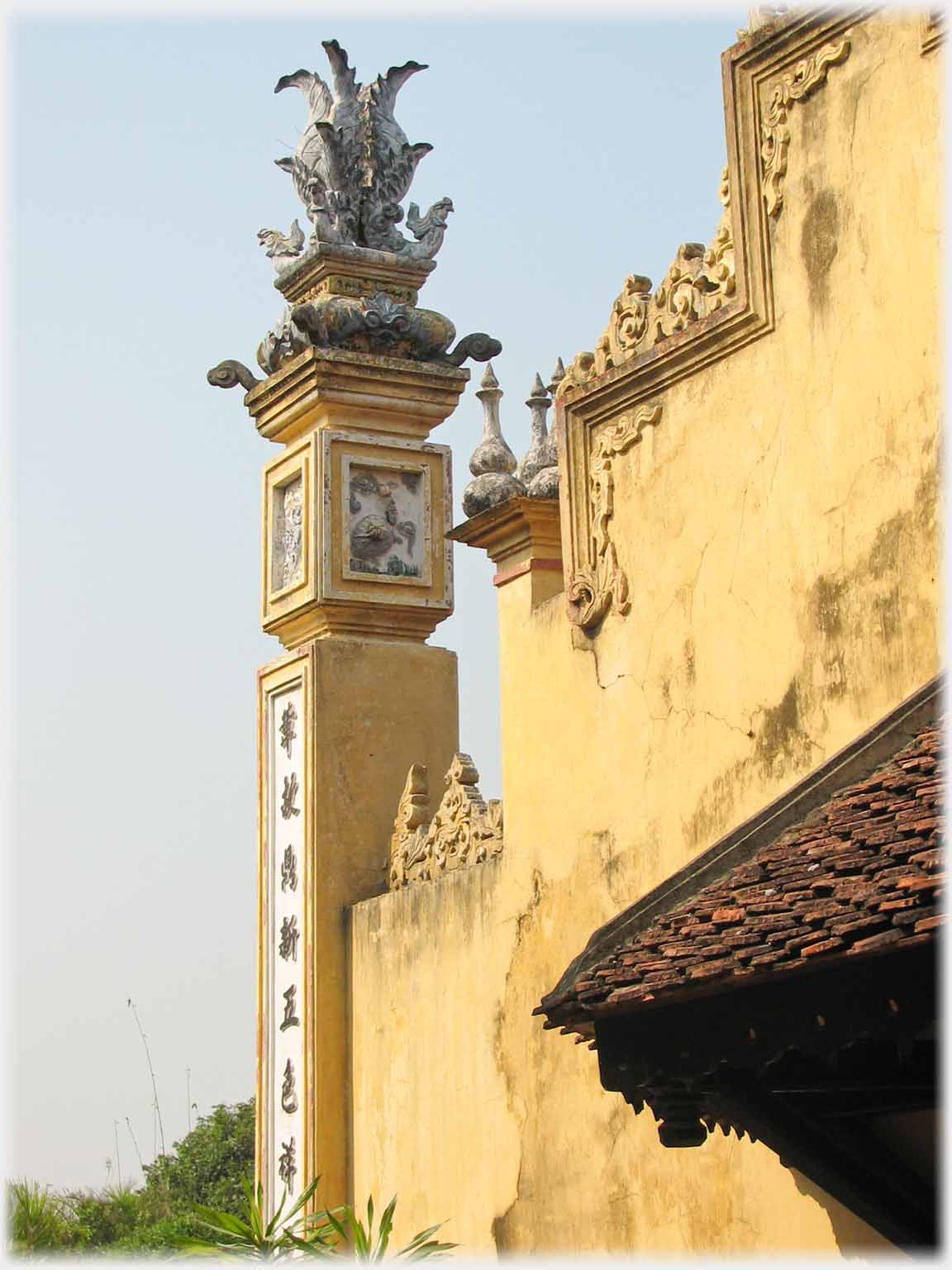 Pillar with decorative top at end of a wall.