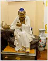 Figurine of man sitting drinking tea