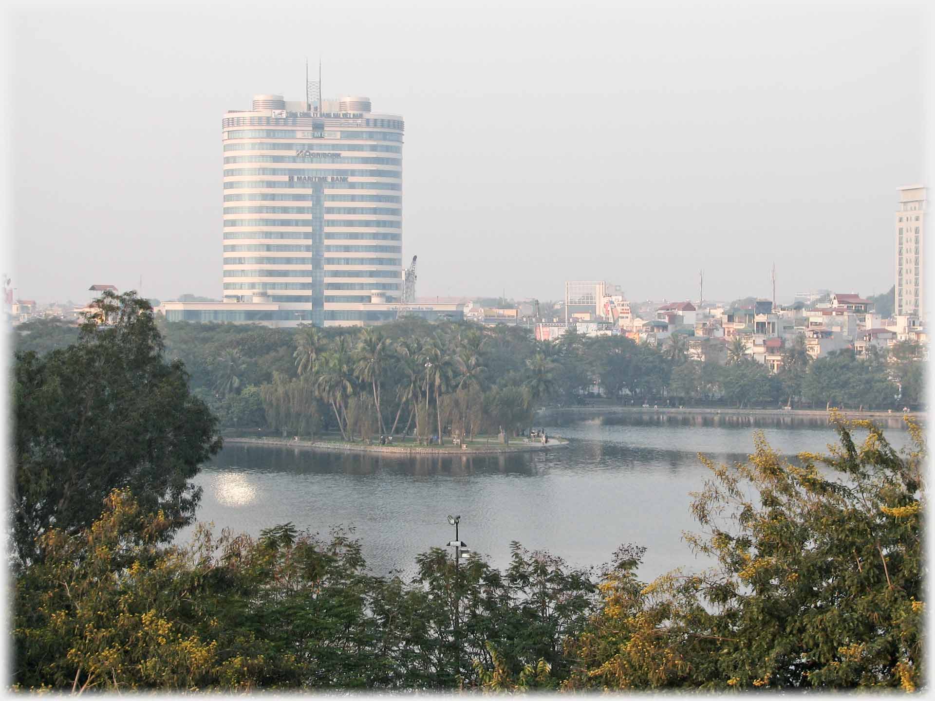 Tower block with Agribank and Maritime Bank names on it, lake in foreground.