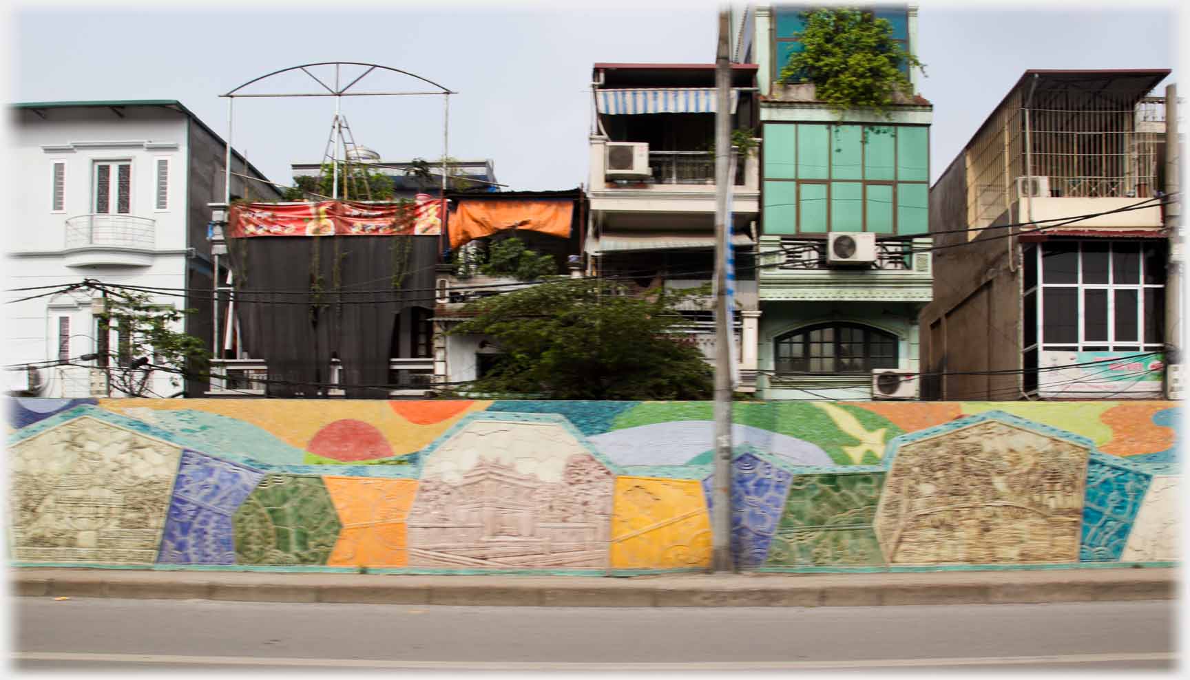 Row of houses with highly decorated wall.