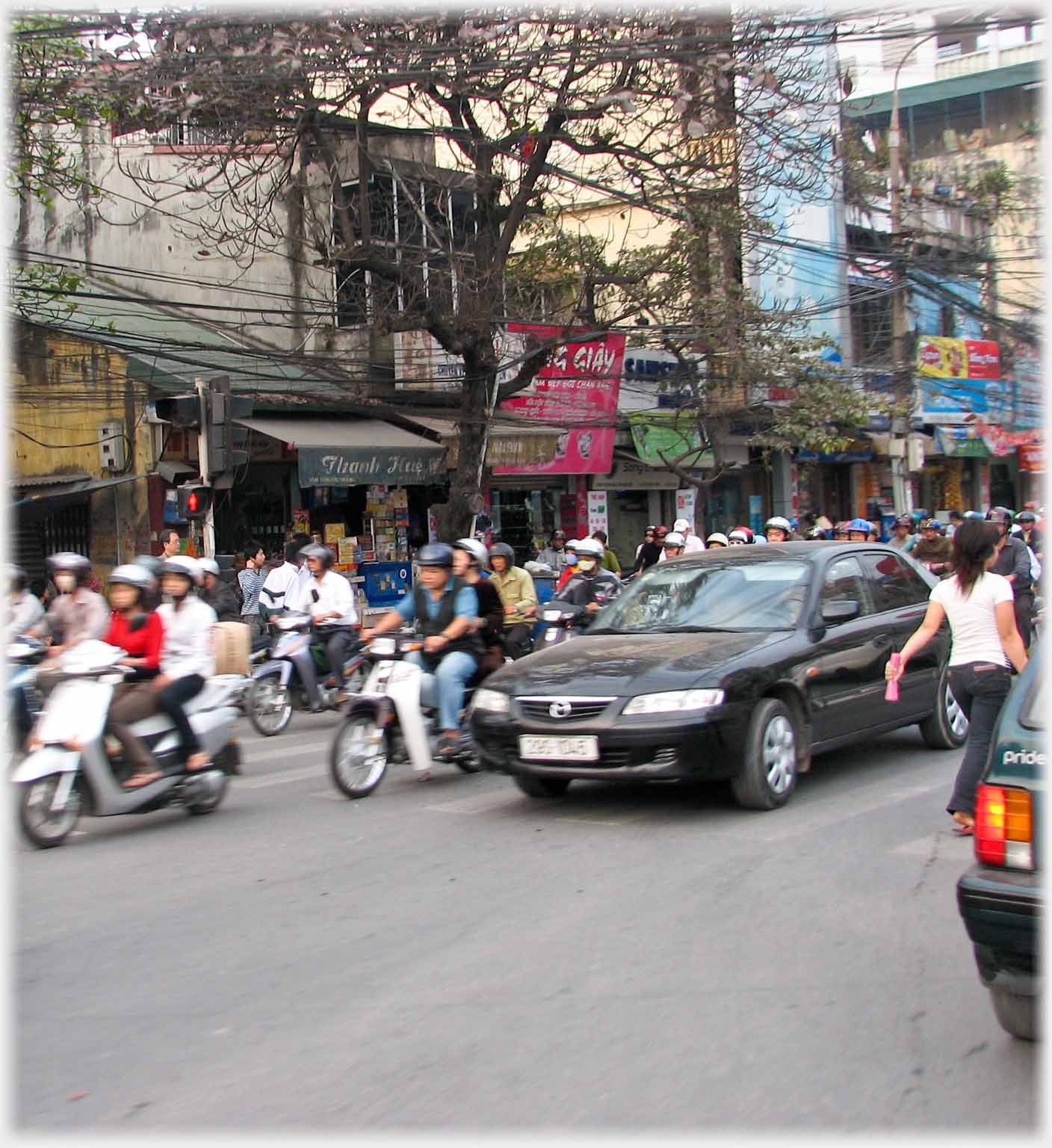 Woman disappearing between cars.