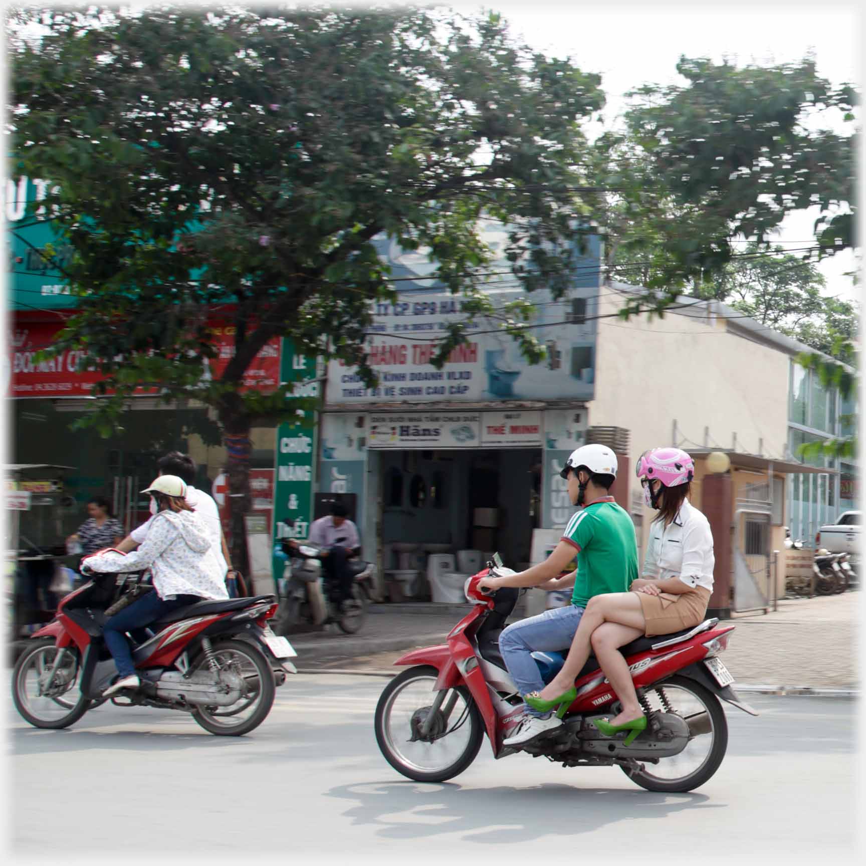 Woman as pillion sitting side saddle.