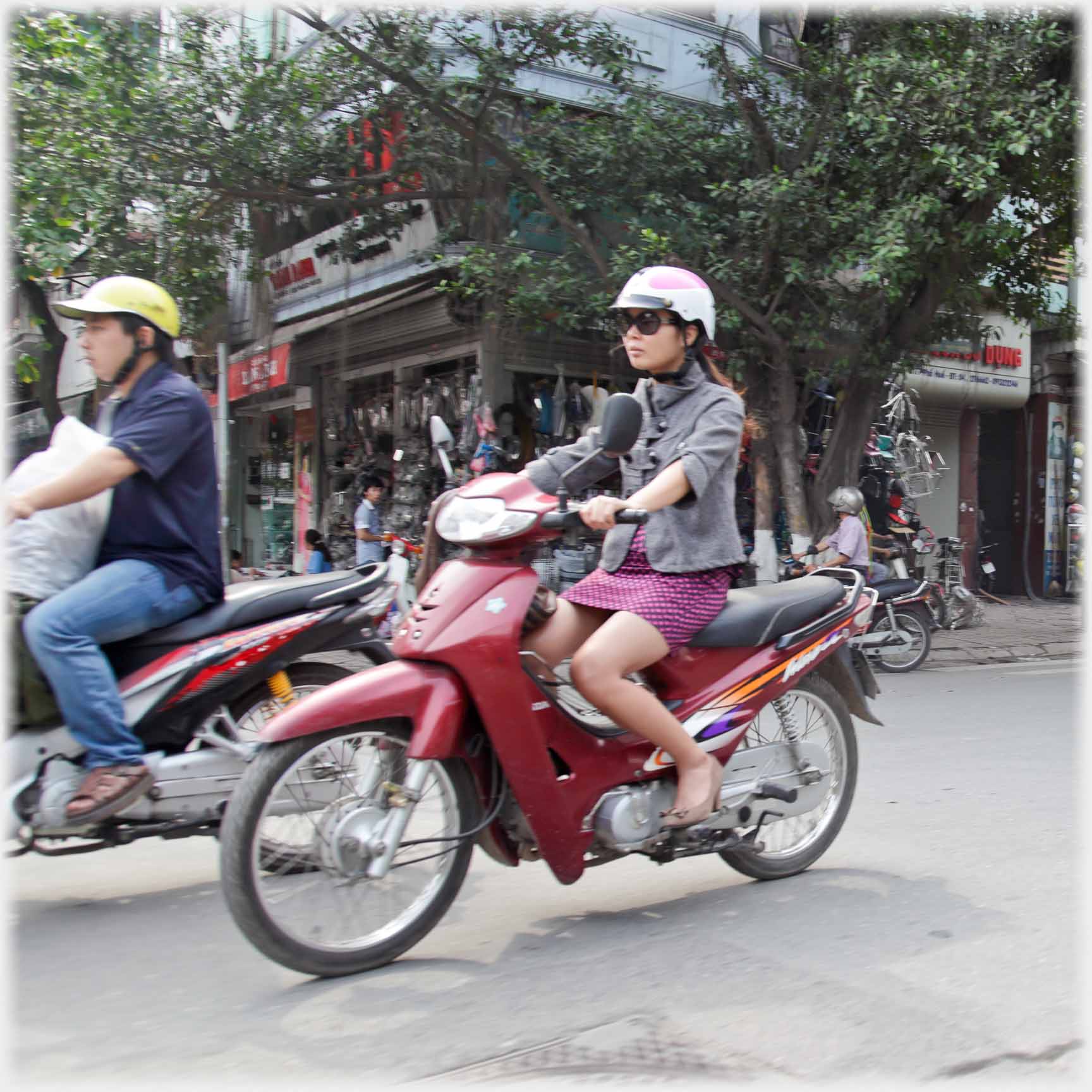 Woman riding motorbike with short skirt.