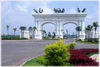 Elaborate double gate with statues of horses on the top.