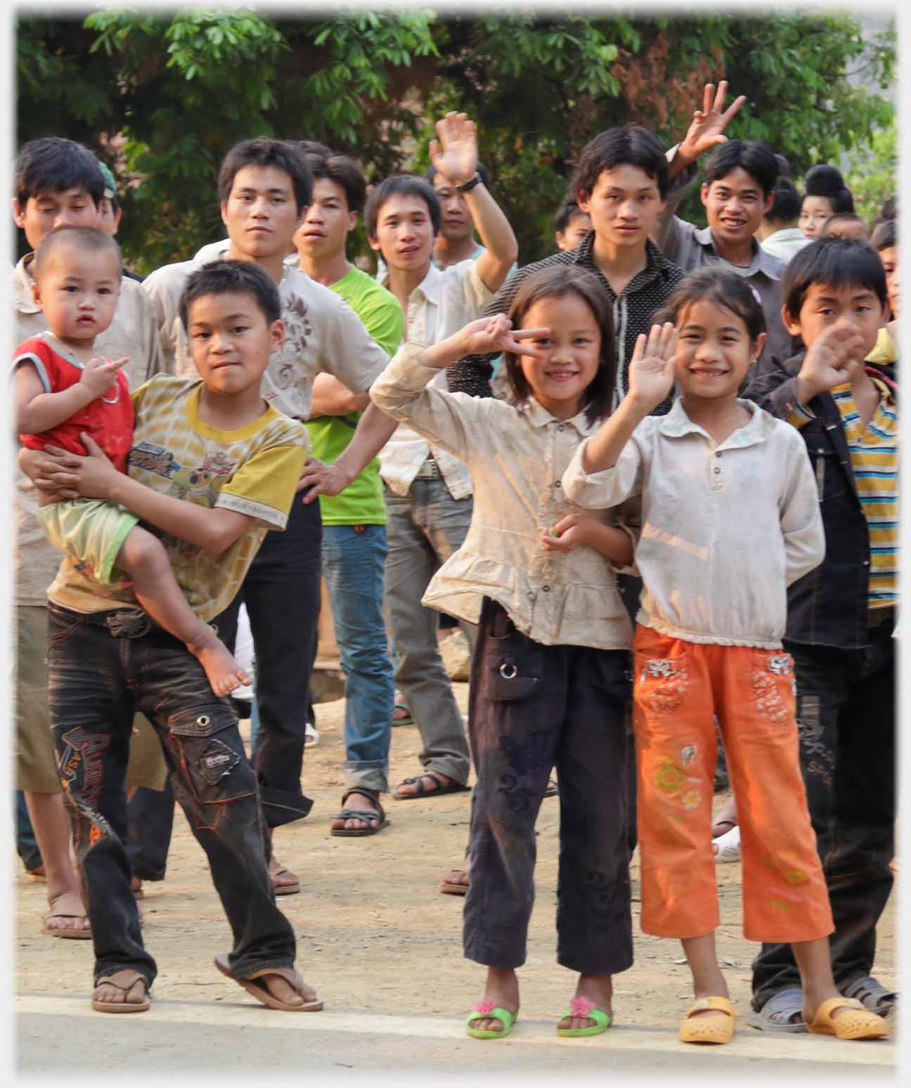 Two girls at front of group waving goodbye.