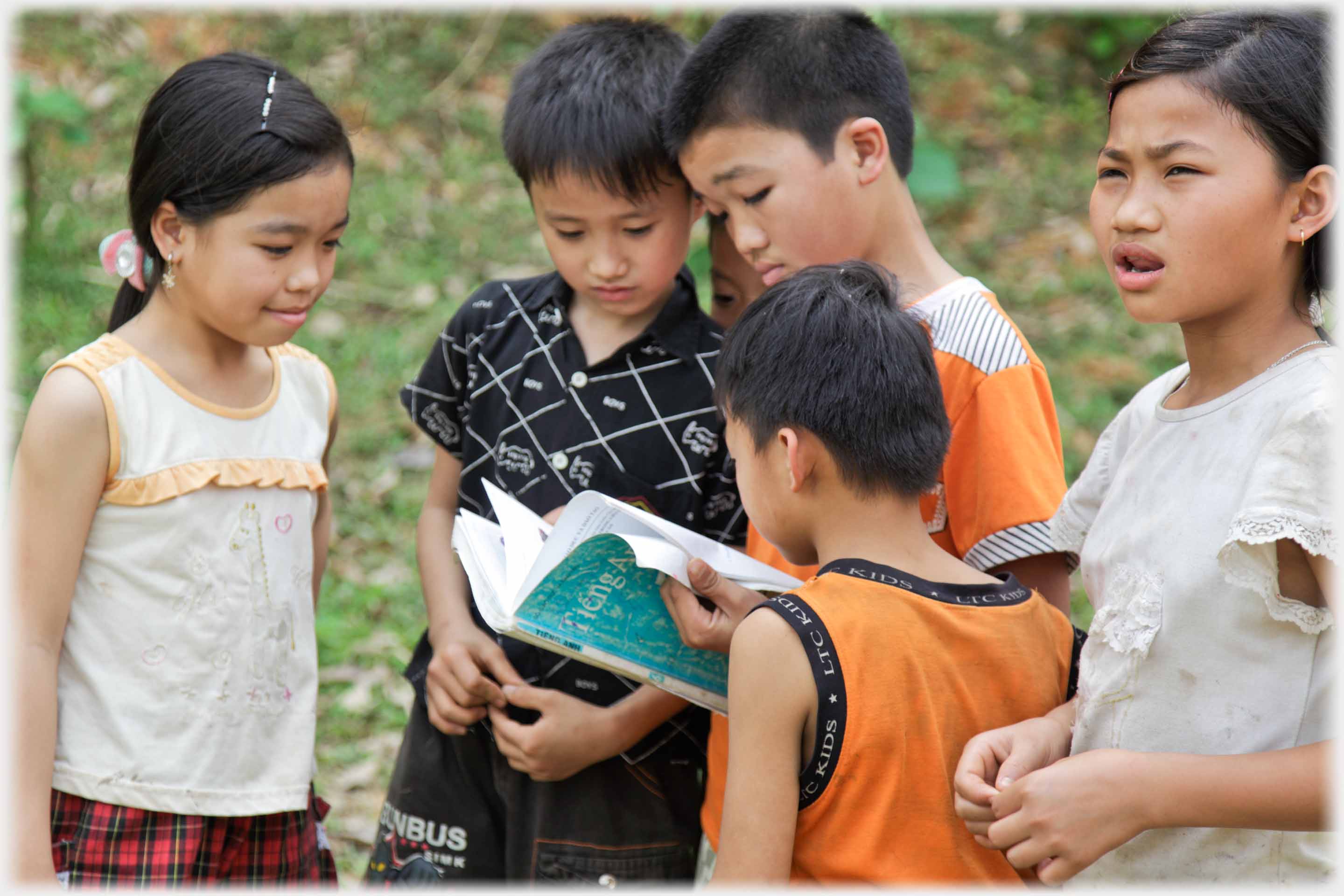 Boys looking at book, girl at man, all puzzled.