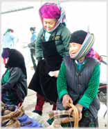 Two older women smilling; in head-scarfs.