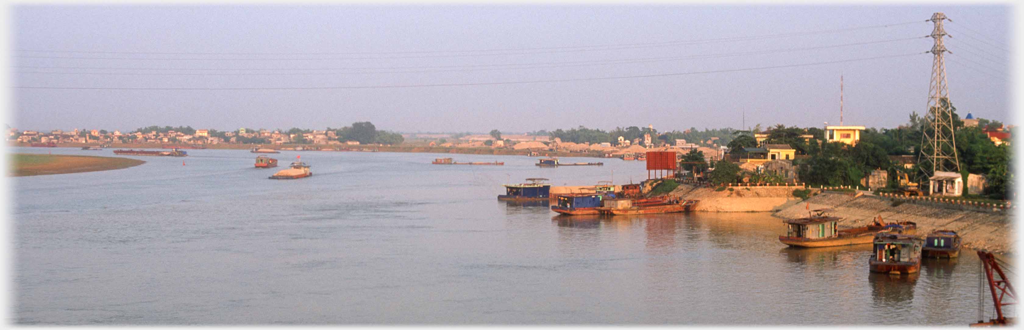 River with barges and pylons.